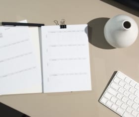 Writing down goals at a desk.